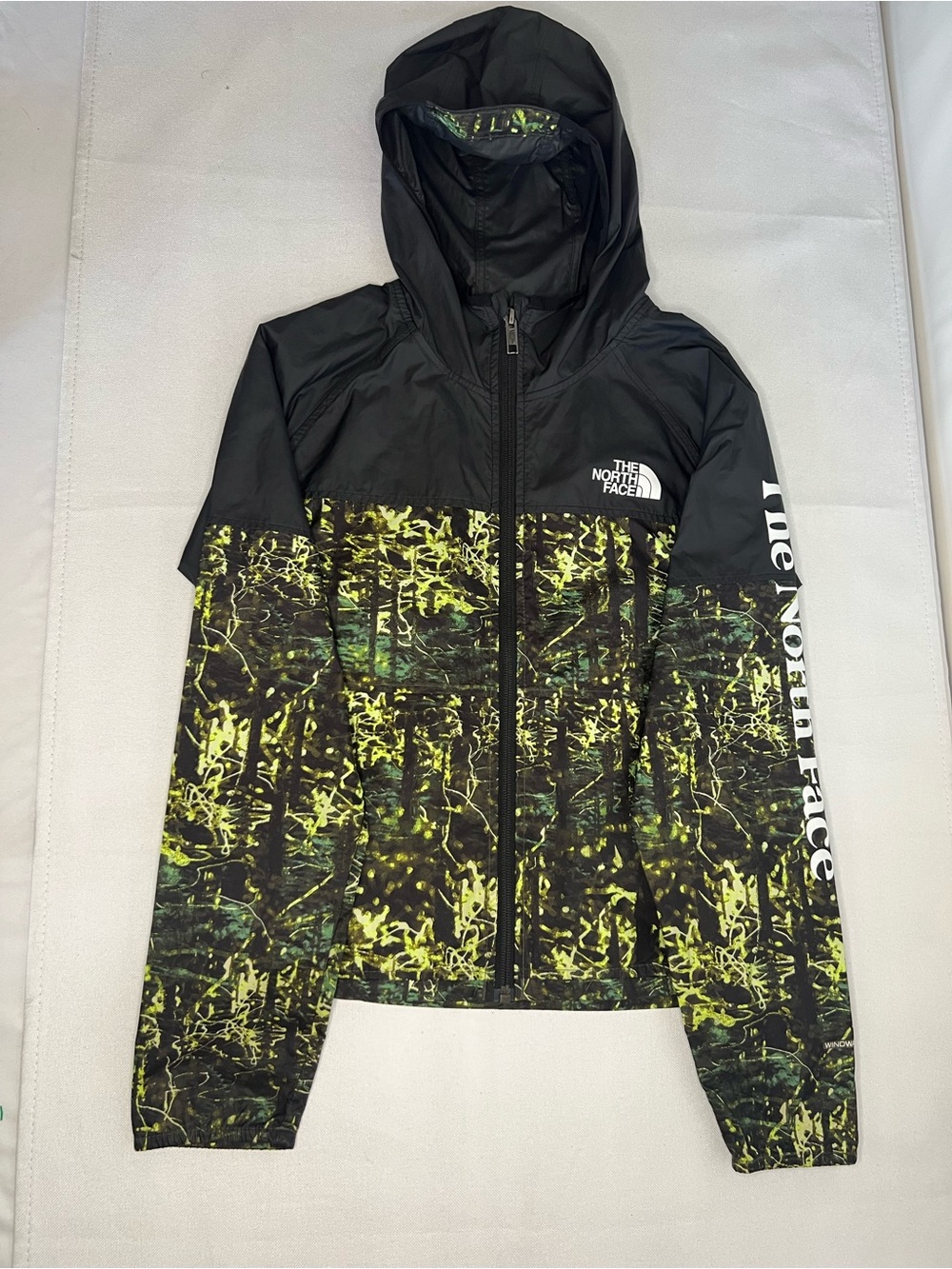 The North Face Kids Black Hooded Rain Jacket with Neon Green Print